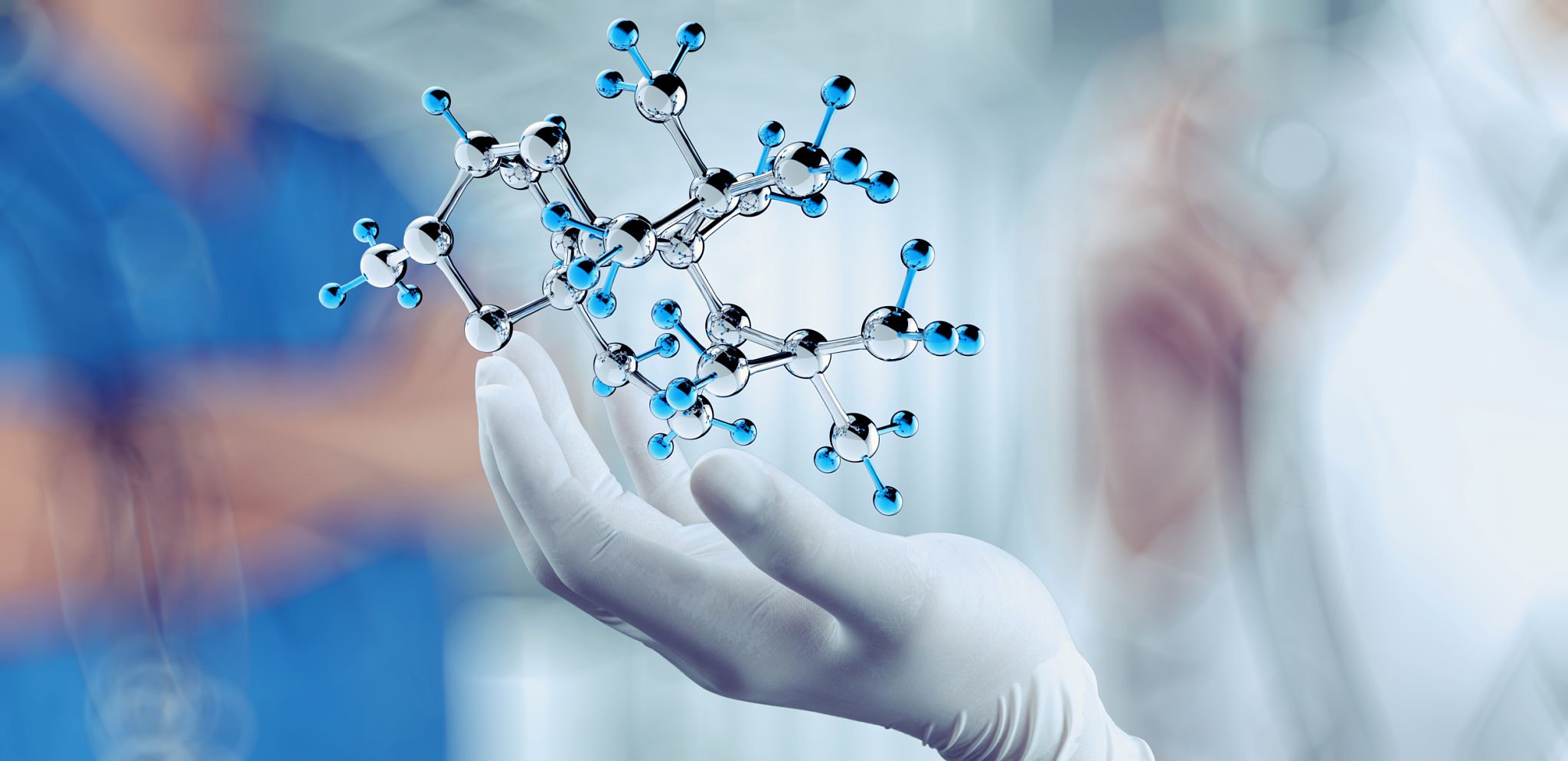 Scientist holding a molecular model with gloved hand.