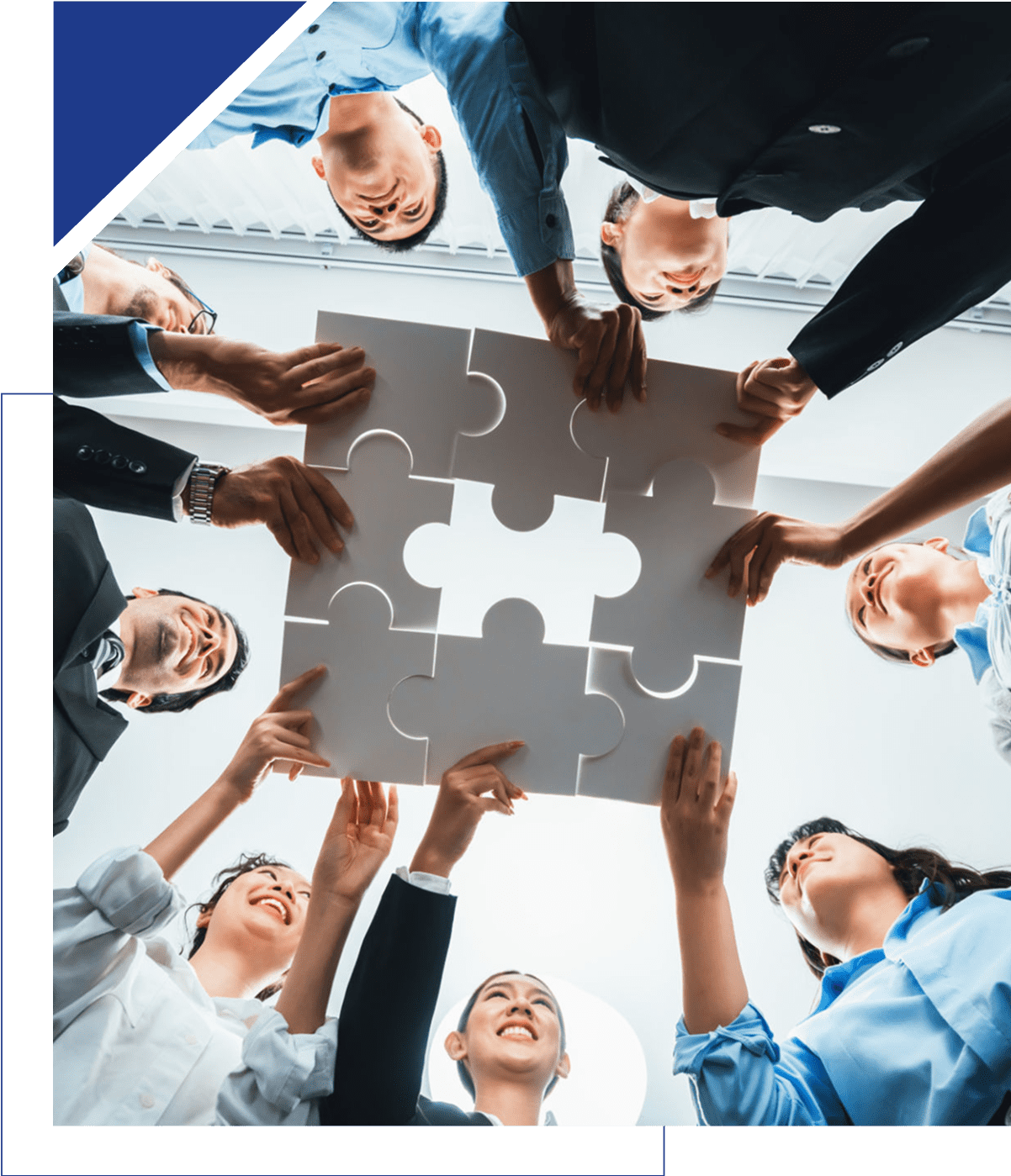 Group of diverse professionals completing a puzzle together, symbolizing teamwork.